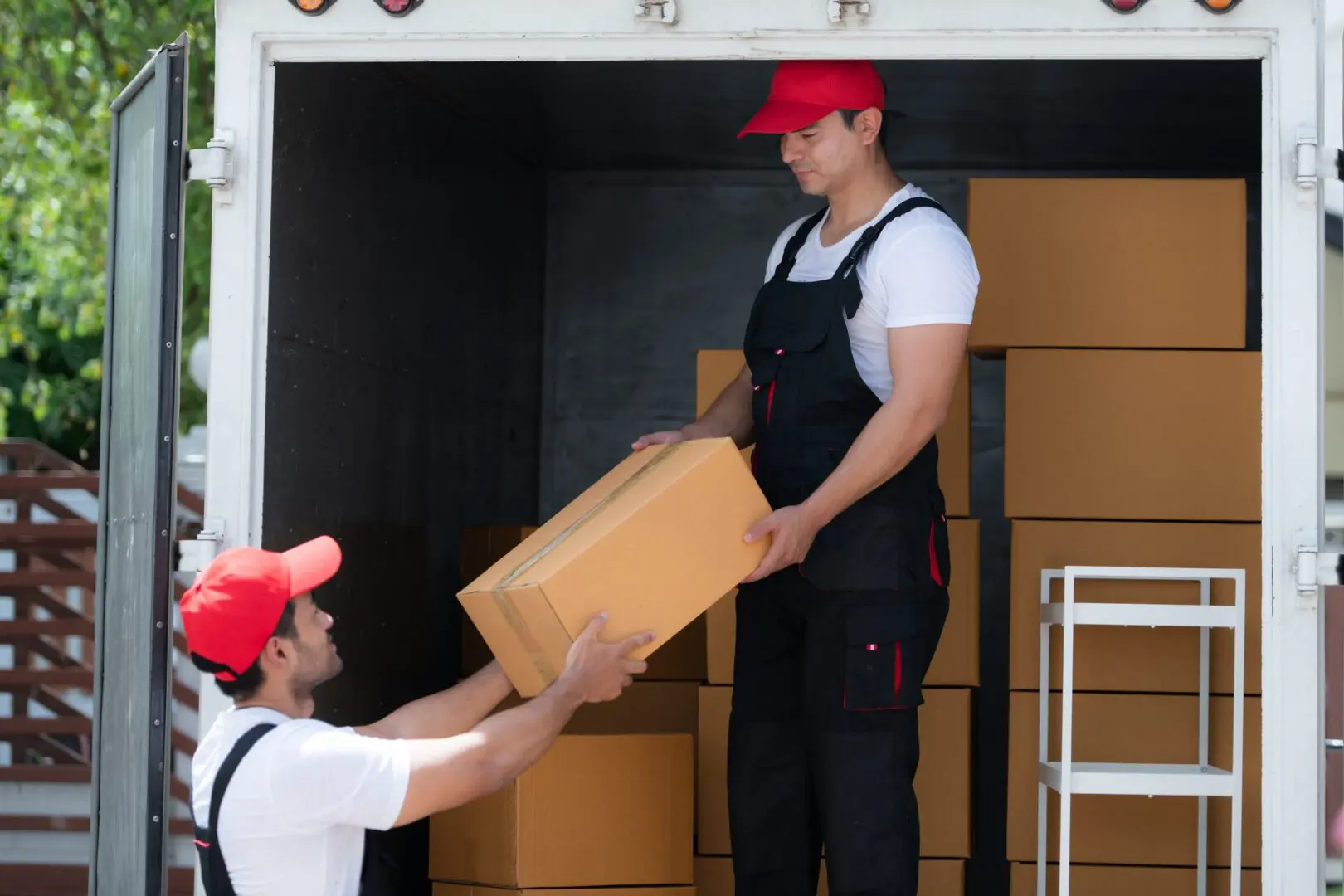 Movers transferring boxes from a truck.